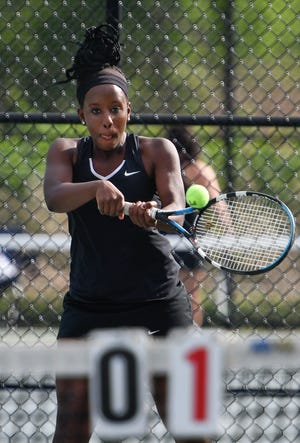 North Andover's first doubles player Tina Gichana joined Jess Langston in one of the Scarlet Knights' two match wins vs. Wilmington, but the Wildcats won the overall match, 3-2. [Wicked Local Staff Photo / David Sokol]