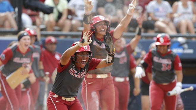 The Oklahoma Sooners celebrate in the decisive fifth inning of their 4-2 semifinal victory Sunday over Oregon at the Women’s College World Series in Oklahoma City. SARAH PHIPPS/THE OKLAHOMAN