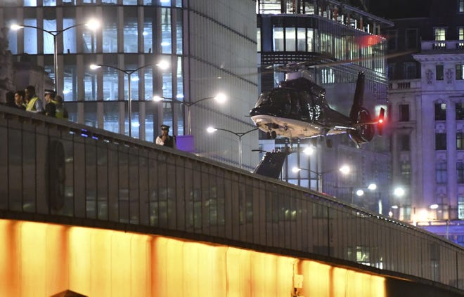 An helicopter lands on London Bridge after an attack in central London, Saturday, June 3, 2017. Armed British police rushed to London Bridge late Saturday after reports of a vehicle running down pedestrians and people being stabbed nearby.

(Dominic Lipinski/PA via AP)