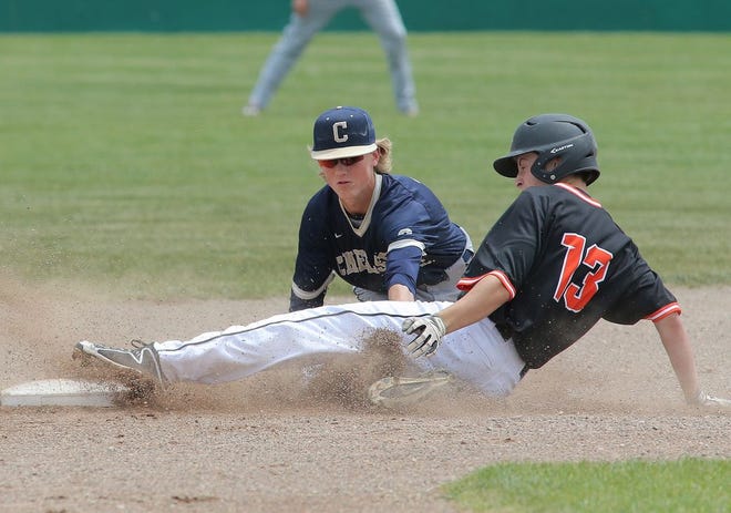 Tecumseh baserunner Hunter Stines, right, slides into second base against Chelsea infielder Hunter Lay during Saturday's district game.