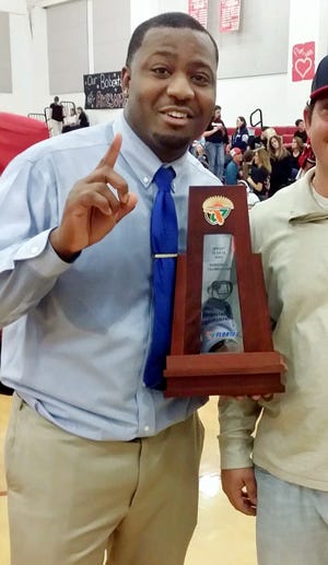 Darcel Austin celebrates after his Laurel Hill boys basketball team won the District 1-1A boys’ basketball championship. [Contributed photo]