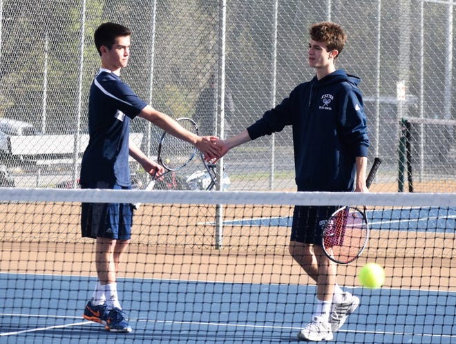 Exeter High School tennis players Tucker Guen, left, and Cam Maher congratulate each other after winning a point during a match earlier this season. [Mike Zhe/file photo]