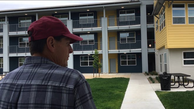 Larry Carter, a 20-year military veteran who until recently was homeless, walks through the courtyard at the new Zettie Miller's Haven affordable housing development on Rosemarie Lane in Stockton. [ROGER PHILLIPS/THE RECORD]