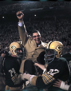 Vince Lombardi of the Green Bay Packers gets carried off the field after defeating the Dallas Cowboys 34-27 in the 1966 NFL Championship Game, on Jan. 1, 1967. (photo courtesy of the Pro Football Hall of Fame)