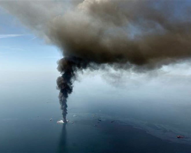 This aerial April 21,2010 file photo, taken in the Gulf of Mexico, more than 50 miles southeast of Venice on Louisiana's tip, shows an oil slick is seen as the Deepwater Horizon oil rig burns. (AP Photo/Gerald Herbert, File)
