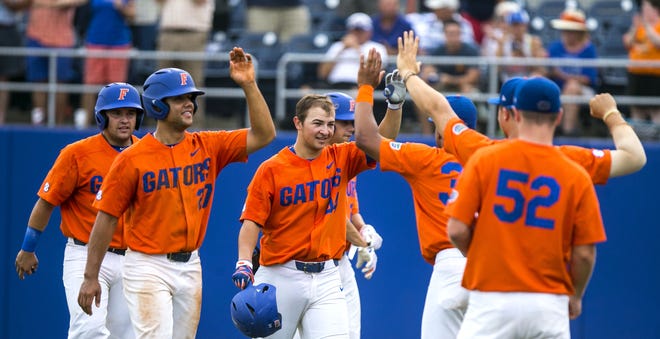Florida Gators outfielder Austin Langworthy (44) gets high-fives from teammates after hitting a three-run homer in the the NCAA Regional final against Bethune Cookman at McKethan Stadium in Gainesville on Monday, June 5, 2017. The Gators beat the Wildcats 6-1 and head to Super Regional next weekend. [Cyndi Chambers / Gatehouse Media]