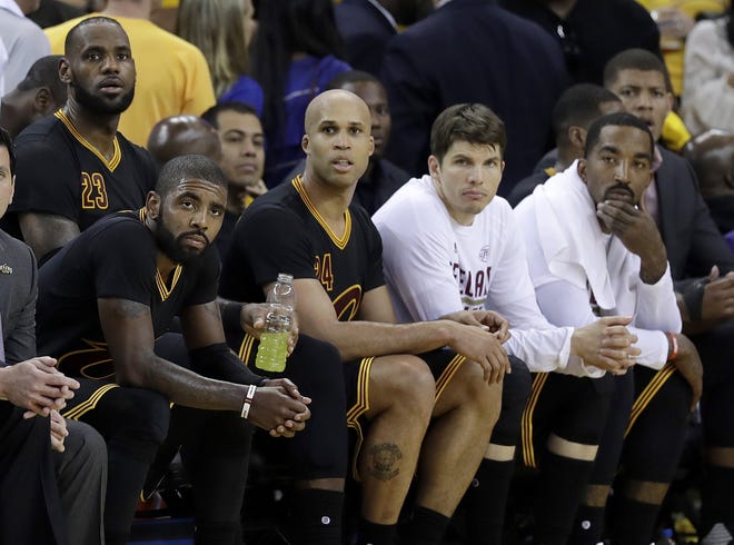 Cleveland Cavaliers' Kyrie Irving, seated from left, LeBron James, Richard Jefferson, Kyle Korver and J.R. Smith sit on the bench during the second half of Game 2 of basketball's NBA Finals against the Golden State Warriors in Oakland, Calif., Sunday, June 4, 2017. (AP Photo/Marcio Jose Sanchez)