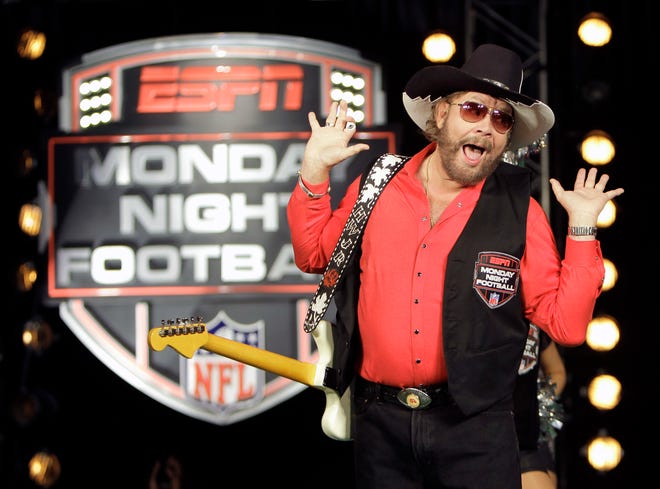 FILE - In this July 14, 2011, file photo, Hank Williams Jr. performs during the recording of a promo for NFL Monday Night Football in Winter Park, Fla. USA Today Network-Tennessee reported on June 5, 2017, that Williams and his "All My Rowdy Friends Are Here on Monday Night" theme are returning to "Monday Night Football." (AP Photo/John Raoux, File)