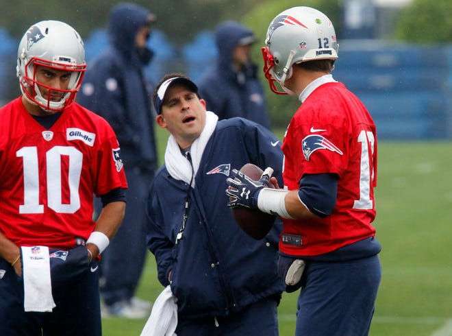 Josh McDaniels talks to Tom Brady (12) as Jimmy Garoppolo (10) listens during a workout on May 25 in Foxboro.