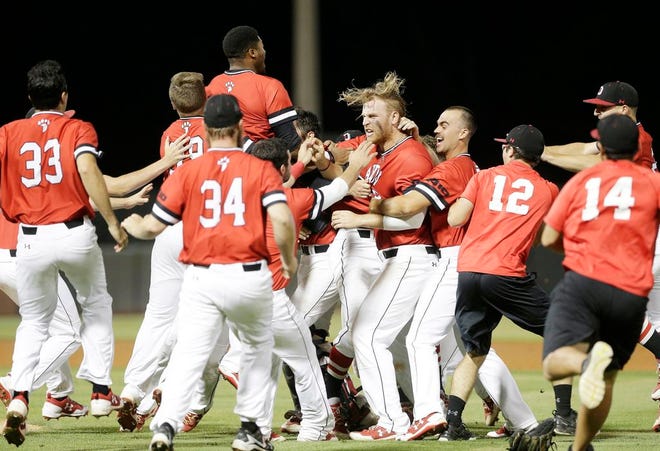 Members of Davidson's baseball team celebrate defeating North Carolina for the second time in three nights in an NCAA regional.