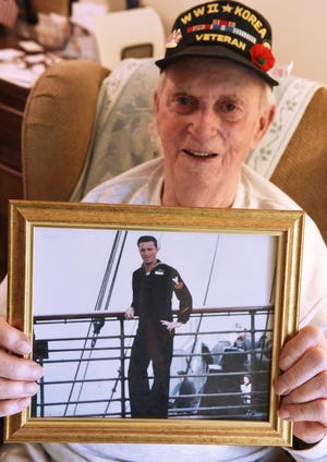 US Navy veteran Fred Caldwell, who served during WWII and the Korean conflict, holds an image of himself while in Korea on Monday, June 5, 2017, in Upper Southampton.