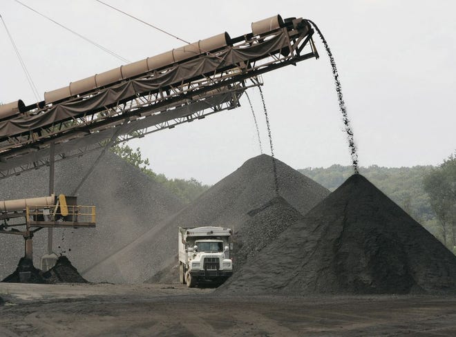 Coal is piled up outside the underground Sterling South mine near Salineville, Ohio, in 2006. [Dispatch file photo]