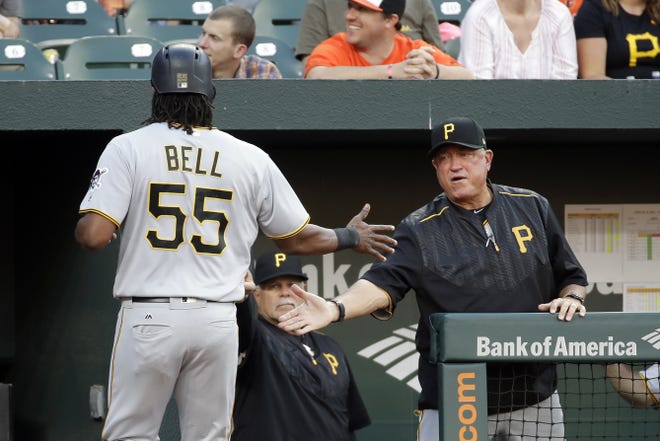 Pittsburgh Pirates manager Clint Hurdle greets Josh Bell after Bell scored on a double by John Jaso in the second inning of an interleague game against the Baltimore Orioles in Baltimore on Tuesday. (AP Photo/Patrick Semansky)