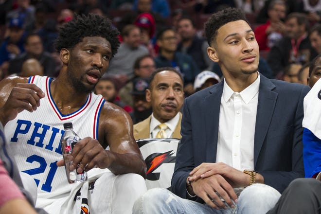 (File) Sixers center Joel Embiid (21) and teammate Ben Simmons chat during a 2016-17 game.
