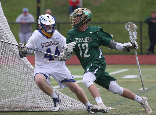 Springfield-Delco's Pat Clemens defends against Lansdale Catholic's Grady Kelly during the PIAA Class 2A boys lacrosse semifinal game at Methacton High School on Tuesday, June 6, 2017. Springfield-Delco won 12-0.