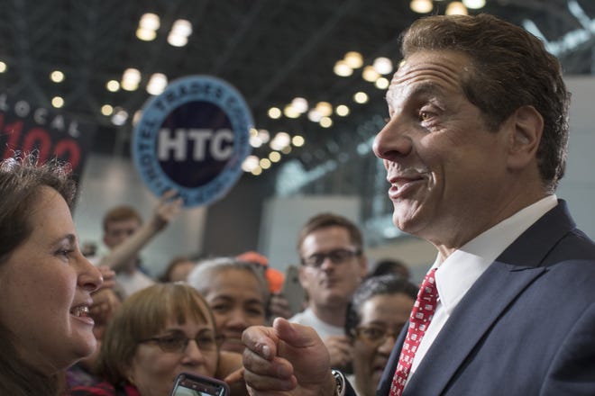 New York Gov. Andrew Cuomo greets members of the audience during a rally Tuesday in New York. Cuomo and House Minority Leader Nancy Pelosi, D-Calif., are hoping to increase the number of congressional seats held by the Democratic Party. [ASSOCIATED PRESS/MARY ALTAFFER]