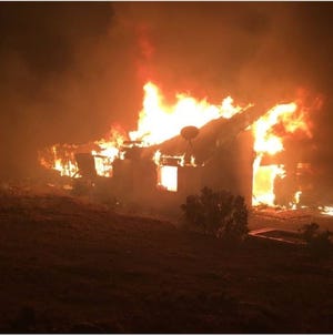 A blaze tore through several outbuildings at a property in Lucerne Valley late Monday. Despite firefighters' best efforts, two residents were left displaced by the blaze. [Photo courtesy of Apple Valley Fire Protection District]