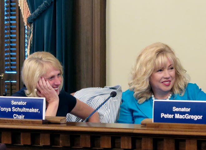 State Rep. Kim LaSata, left, R-Bainbridge Township, and Sen. Tonya Schuitmaker, R-Lawton, listen after they voted for a $1.6 billion higher education budget bill that advanced out of a House-Senate conference committee, Tuesday, June 6, 2017, at the Capitol in Lansing, Mich. Schuitmaker said she hopes to still give universities more state funding depending on how high-level talks proceed between Michigan Gov. Rick Snyder and legislative leaders, who are at odds over teacher pensions. (AP Photo/David Eggert)