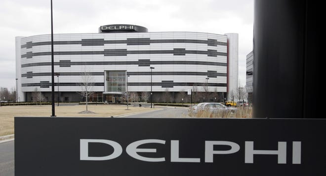 FILE - In this March 22, 2006, file photo, Delphi's World Headquarters is shown in Troy, Mich. Automotive electronics and parts maker Delphi and French transport company Transdev have plans to use autonomous taxis and a shuttle van to carry passengers on roadways in France without a human behind the wheel as early as 2018. The companies announced the partnership Wednesday, June 7, 2017, and said it could be the first deployment of autonomous taxis and vans on real roads without human backup pilots. (AP Photo/Carlos Osorio, File)