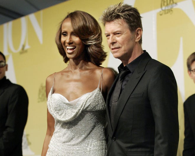 Iman and husband David Bowie pose at the 2005 CFDA Fashion Awards in New York. [AP Photo/Stuart Ramson, File]