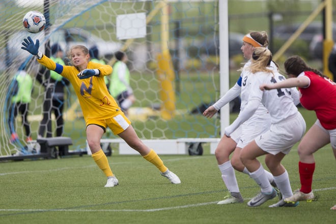Belvidere North goalie Erin McKinney (32), shown reaching to block a shot against Woodstock Marian in the Class 2A regional finals, was named NIC-10 soccer MVP. [RRSTAR.COM FILE PHOTO]