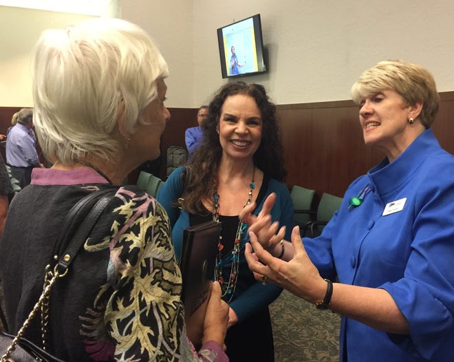 Karen Holbrook, left, vice president at the University of South Florida, huddles with USF professor Kathy Black, center, and Patterson Foundation CEO Debra Jacobs at a celebration of Age-Friendly Sarasota's first two years. [HERALD-TRIBUNE STAFF PHOTO / BARBARA PETERS SMITH]