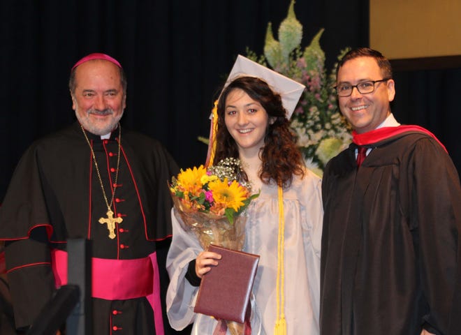 Bishop Stang salutatorian Sarah Hamel of Acushnet was recognized during Sunday's 55th annual graduation ceremonies for being the school's official 10,000th alumni. Marking the honor was Fall River Diocese Bishop Edgar da Cunha and school president Peter Shaughnessy. [ROBERT BARBOZA/THE ADVOCATE/SCMG]