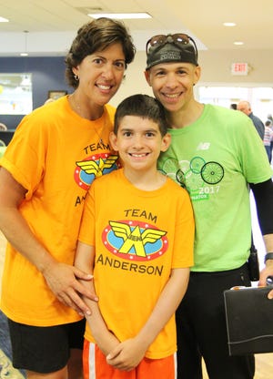 Jennifer Anderson, Abraham Anderson and Cranberry Country PMC Kids Ride founder Bill Goldsmith get together for a photo after Sunday's ride. Abraham, in honor of him mom who is a cancer survivor, asked his friends for donations to the PMC Kids Ride in the place of gifts at his recent 10th birthday party. In all, Team Anderson contributed $2,600 to this year's fundraising effort, which is expected to surpass $40,000 dollars. Jon Haglof/The Gazette/SCMG