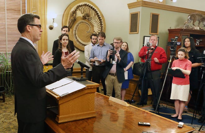 Gov. Sam Brownback gave a statement to the media Wednesday morning concerning the Senate and House overriding his veto of a bill raising Kansas income taxes by $1.2 billion over two years. The governor left the news conference without taking questions. (Thad Allton/The Capital-Journal)