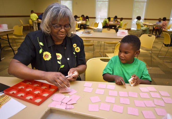 Wanda Allen and her grandson Joseph Irvin, 4, play a memory game Wednesday during the Mayor's Summer Reading Club at the downtown Augusta Library. Free lunch is provided at club meetings, and the club meets Mondays, Tuesdays and Wednesdays.