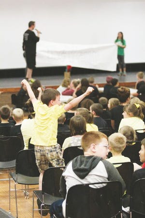An Addison Elementary School student celebrates May 26 as the winner of a competitive four-house behavior program is announced. The elementary students are rewarded throughout the year for good behavior, with the top “house” earning a trip to the Christian Family 
Centre water park in Adrian.