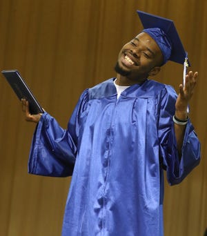 Marques Lovett reacts to receiving his certificate during his graduation ceremony Thursday afternoon, June 8, 2017, at Webb Street School in Gastonia, North Carolina. [Mike Hensdill/The Gaston Gazette]