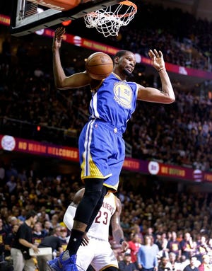 Golden State Warriors forward Kevin Durant (35) dunks against the Cleveland Cavaliers during the first half of Game 3 of basketball's NBA Finals in Cleveland, Wednesday, June 7, 2017.