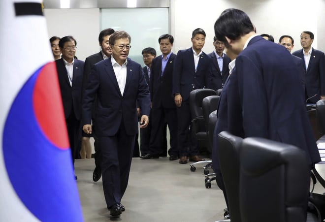 South Korean President Moon Jae-in, left, arrives to attend a meeting of the National Security Council at the presidential Blue House in Seoul, South Korea, Thursday, June 8, 2017. North Korea fired several suspected short-range anti-ship missiles Thursday, South Korea's military said, in a continuation of defiant launches as it seeks to build a nuclear missile capable of reaching the continental United States. YONHAP VIA AP