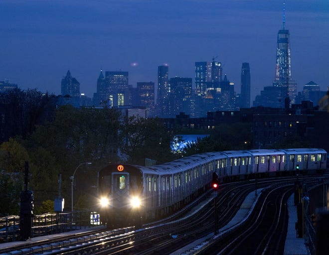 A No. 7 subway train rides the rails in the New York City borough of Queens. At $2.75 a ride, the subway is the cheapest and most efficient way to travel across the city. [AP, file / Mark Lennihan]