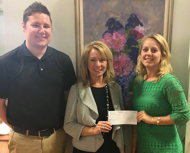 Pawcatuck Branch Manager Kathryn Tracey delivers a check to Jonnycake Center Executive Director Elizabeth Pasqualini and soon to be Executive Director Lee Eastbourne.