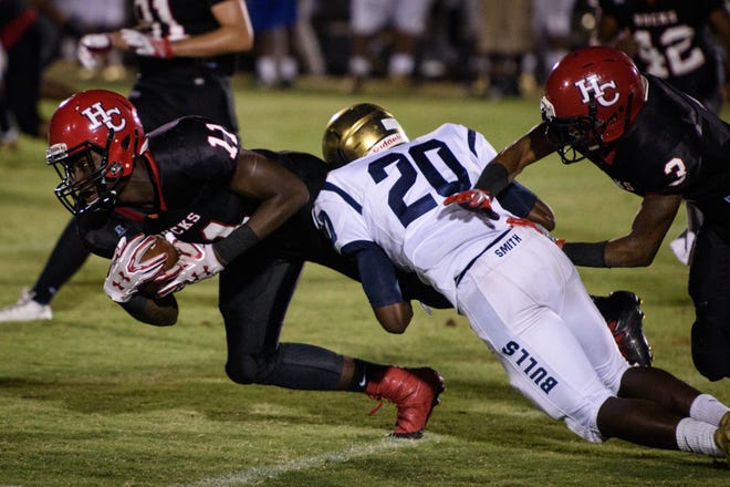 Hoke County's Andre Pegues gets tackled by E.E. Smith's Jerry Davis during a game last season. The rising senior who's played numerous positions on offense for the Bucks averaged 20.4 yards per catch on 11 receptions last season. [FAYETTEVILLE OBSERVER FILE PHOTO]