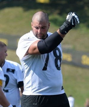 Steelers lineman Alejandro Villanueva wipes his face during the first day of training camp in 2016 at St. Vincent College in Latrobe.