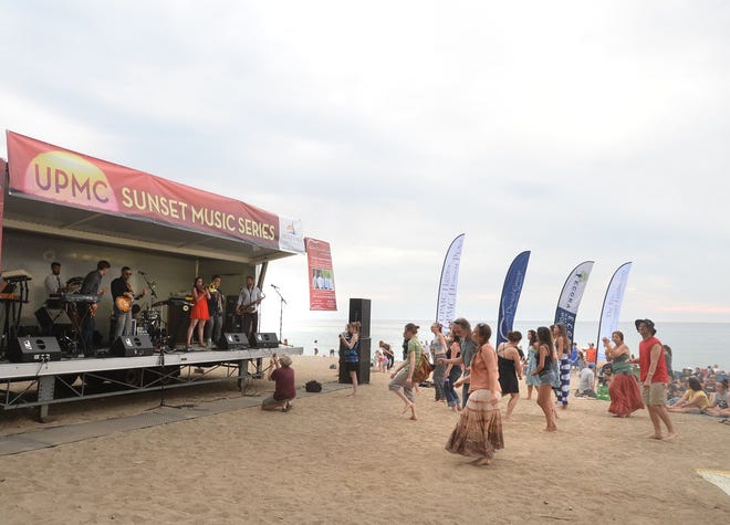 A crowd dances during a 2016 UPMC Sunset Music Series concert on Presque Isle's Beach 1. The free weekly series returns Wednesday. [FILE PHOTO/ERIE TIMES-NEWS]