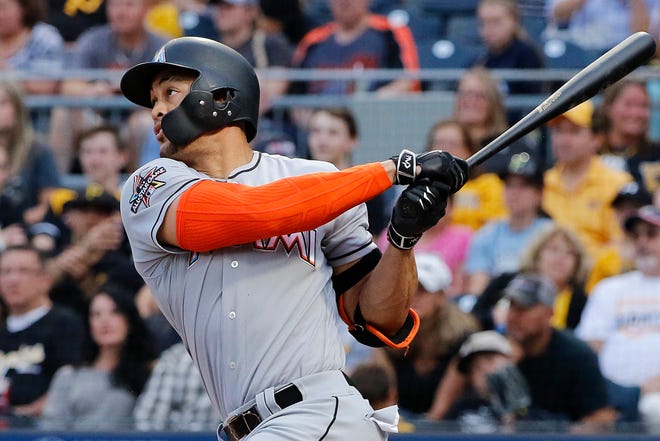 Miami Marlins' Giancarlo Stanton follows through on a solo home run off Pittsburgh Pirates starting pitcher Tyler Glasnow during the third inning of a baseball game in Pittsburgh, Friday, June 9, 2017. (AP Photo/Gene J. Puskar)
