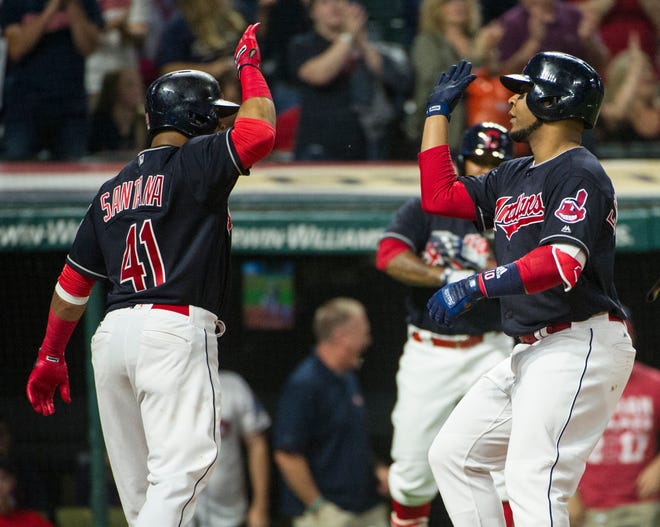 Cleveland Indians' Carlos Santana (41) greets Edwin Encarnacion, after Encarnacion's two-run home run off Chicago White Sox starting pitcher Miguel Gonzalez during the fifth inning of a baseball game in Cleveland, Friday, June 9, 2017. (AP Photo/Phil Long)