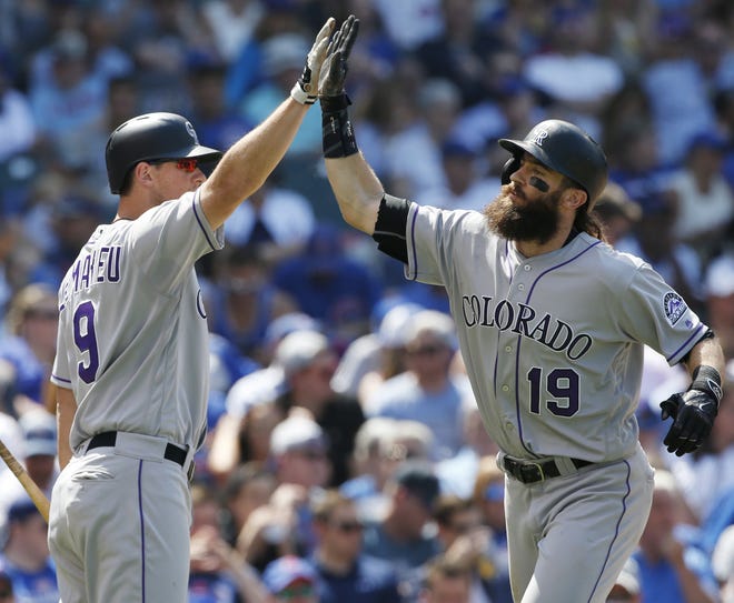 Colorado Rockies' Charlie Blackmon, right, celebrates with DJ LeMahieu after hitting a two-run home run against the Chicago Cubs during the fifth inning of a baseball game Friday, June 9, 2017, in Chicago. (AP Photo/Nam Y. Huh)
