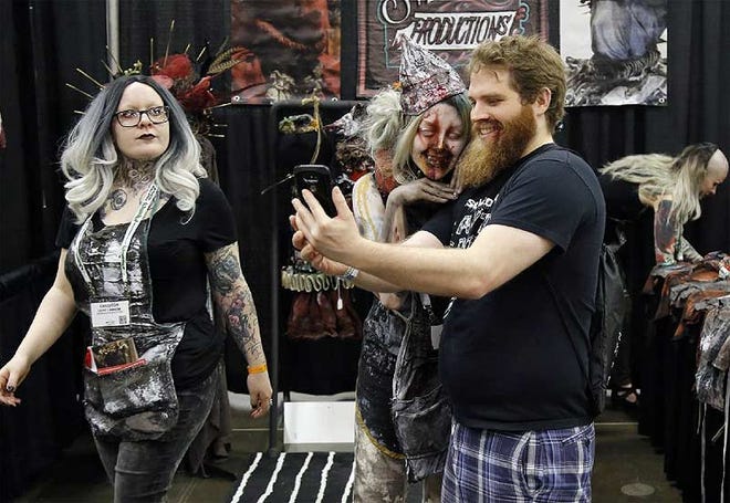 Andrew Polzin from Wisconsin gets a selfie with Ashely Keel of Svenpuss Production during the Columbus Convention Center host the Midwest Haunters Convention, a gathering of haunted attraction operators to talk about the latest scares on June 10, 2017. [Kyle Robertson/Dispatch]