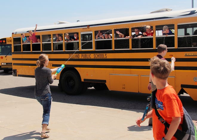 Students at Zeeland's Adams Elementary get a send-off to summer from their teachers in the forms of water guns and noisemakers on the last day of school on Friday, June 9. [Erin Dietzer/Sentinel staff]