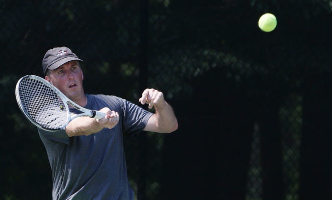 Rick Thomason returns the ball in a doubles match with John Edwards against Jonathan Wingo and Shawn Tai during the Advantage Realty Cup at the NorthRiver Tennis Pavilion at NorthRiver Yacht Club in Tuscaloosa on Saturday. [Staff Photo/Erin Nelson]
