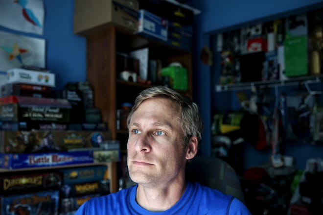 Sean R. Frazier sits for a portrait in his home office on Monday. Frazier published his first fantasy novel, "The Call of Chaos," in November. [Timothy Tai/Tribune]