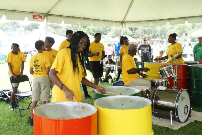Bianca Brooks handles the tenor line, as part of the Lake Steel Orchestra, Saturday at the Clermont Jerk Festival. [LINDA CHARLTON / CORRESPONDENT]