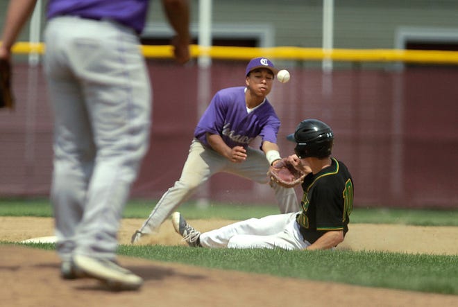 North Smithfield's Chris Matulaitis, who was also the winning pitcher, slides safely into second with a stolen base as the throw gets away from Classical's James Dorant during Sunday's Division III finals at Rhode Island College.