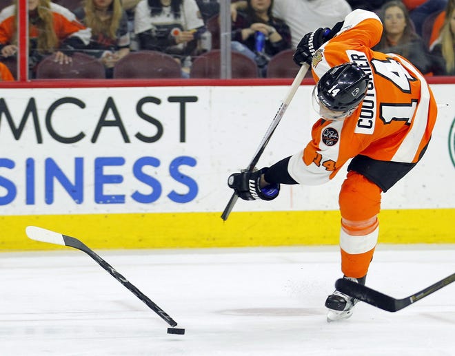 FILE - In this April 9, 2017, file photo, Philadelphia Flyers' Sean Couturier breaks his stick while taking a shot on a break away during the second period of an NHL hockey game against the Carolina Hurricanes in Philadelphia. Despite technological advances that turn carbon fiber into one-piece, fine-tuned machines that are custom made for each NHL player to become extensions of their hands, hockey sticks can still break. And, sometimes it happens at the worst times. [TOM MIHALEK/THE ASSOCIATED PRESS]
