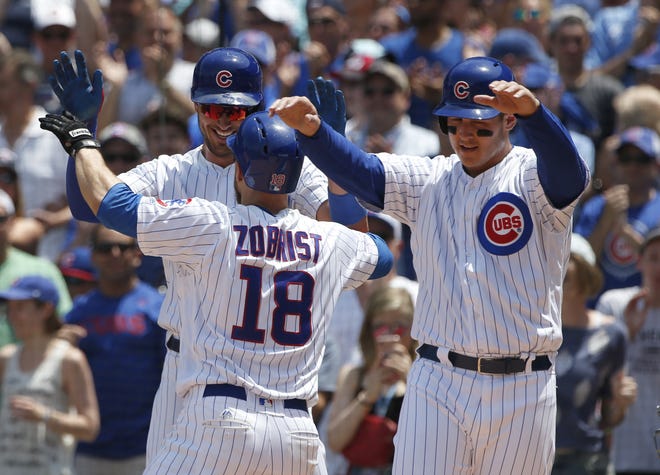 Chicago Cubs' Ben Zobrist (18) celebrates with Kris Bryant, left, and Anthony Rizzo after hitting a three-run home run during the first inning of a baseball game against the Colorado Rockies, Sunday, June 11, 2017, in Chicago. (AP Photo/Nam Y. Huh)